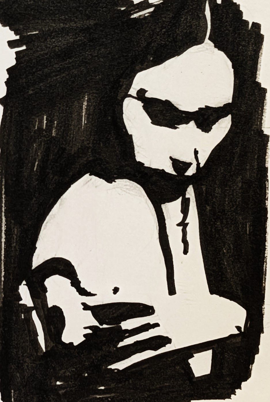 Ink notan study of a bowed head resting on a hand