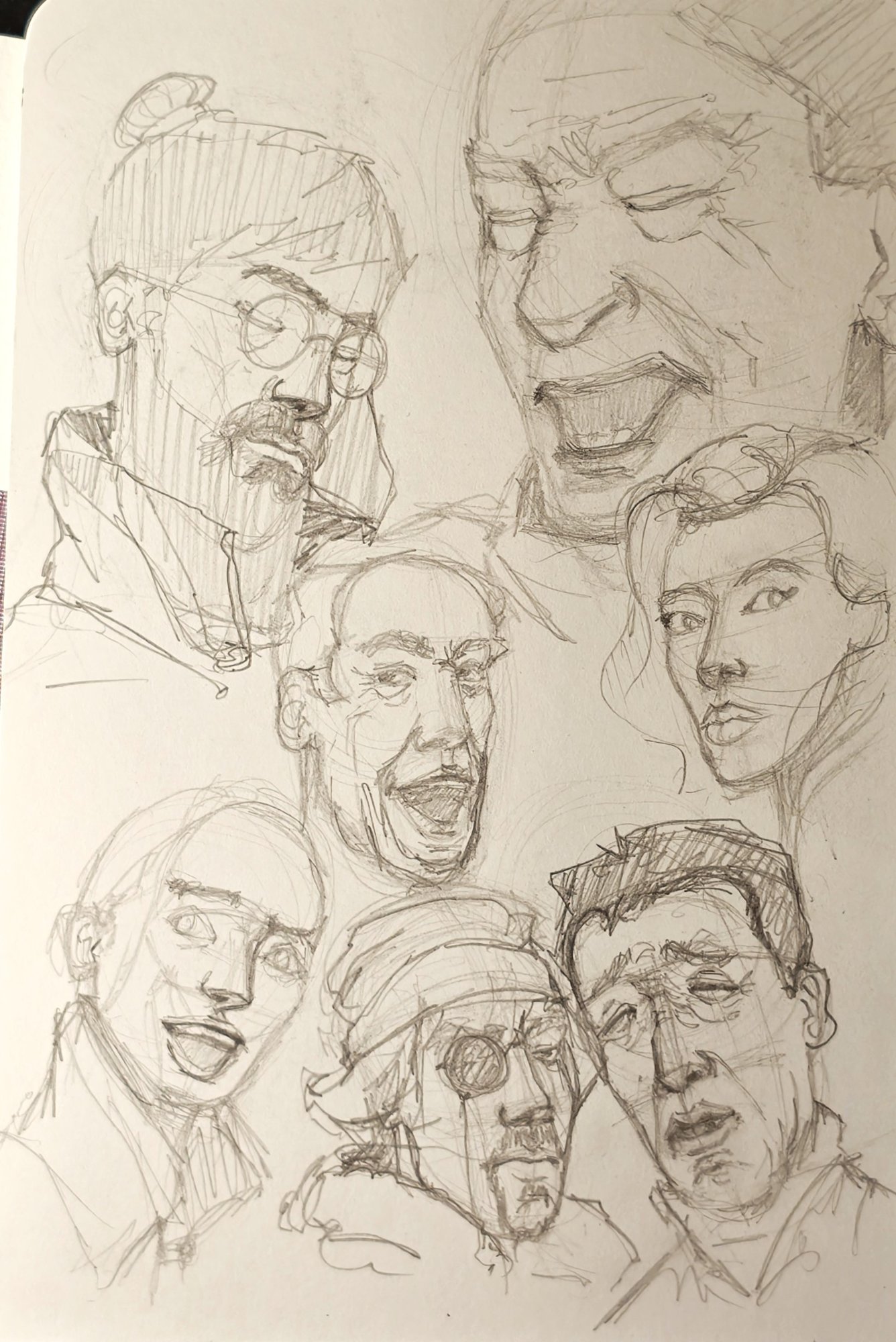 Sketchbook page of quick pencil heads with basic expressions