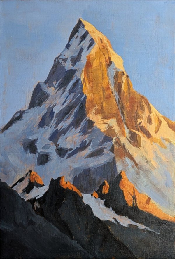 Acrylic painting of a mountain peak lit orange by low sun on one face, blue-grey shadow on the other, against a pale blue sky